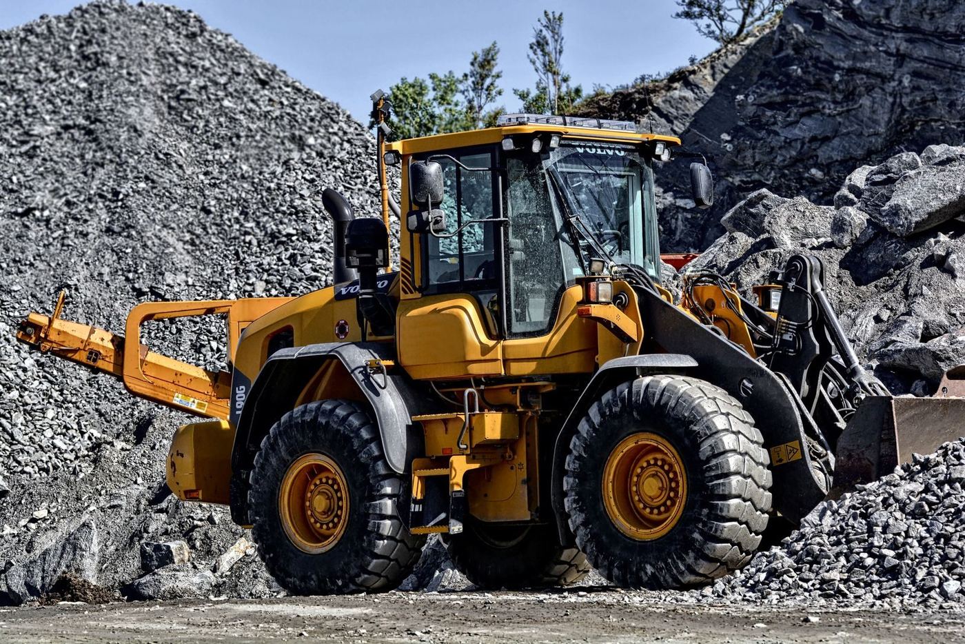 Wheel loader working a stockpile of sand and aggregate